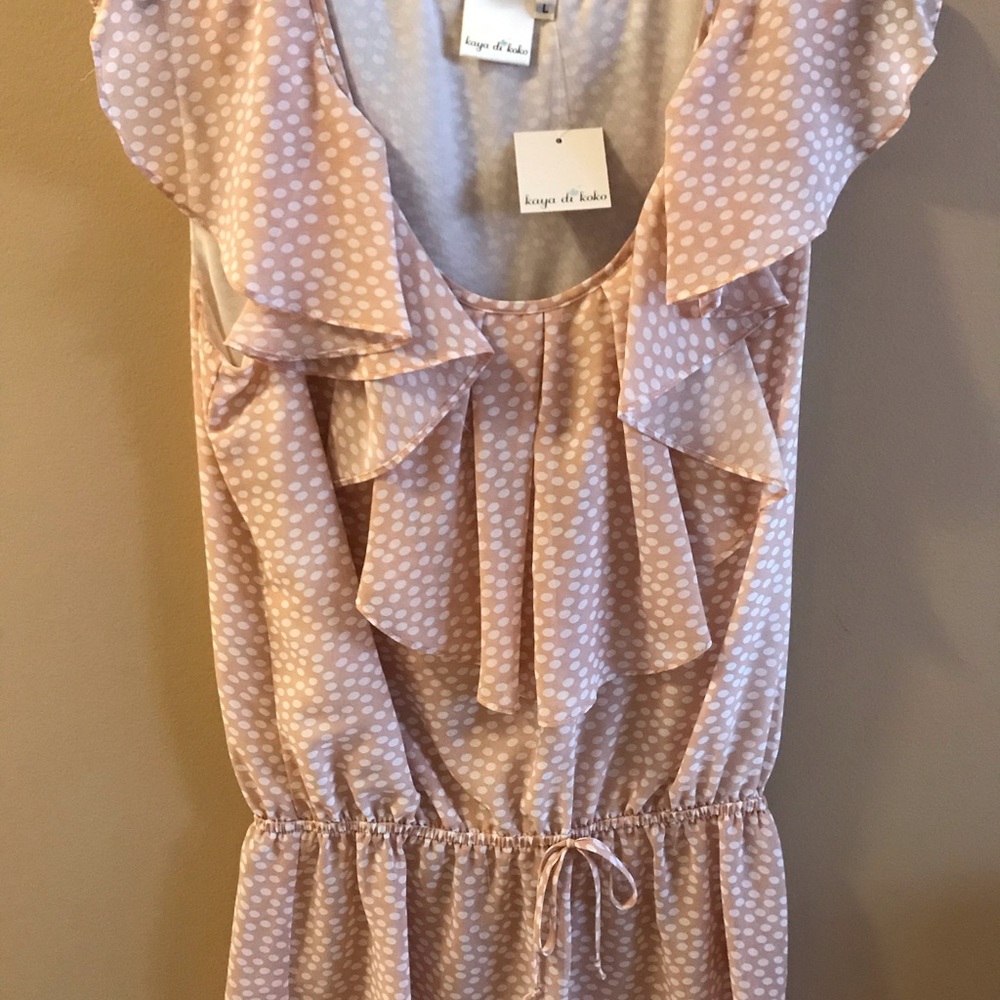 Pink and white sleeveless ruffled blouse